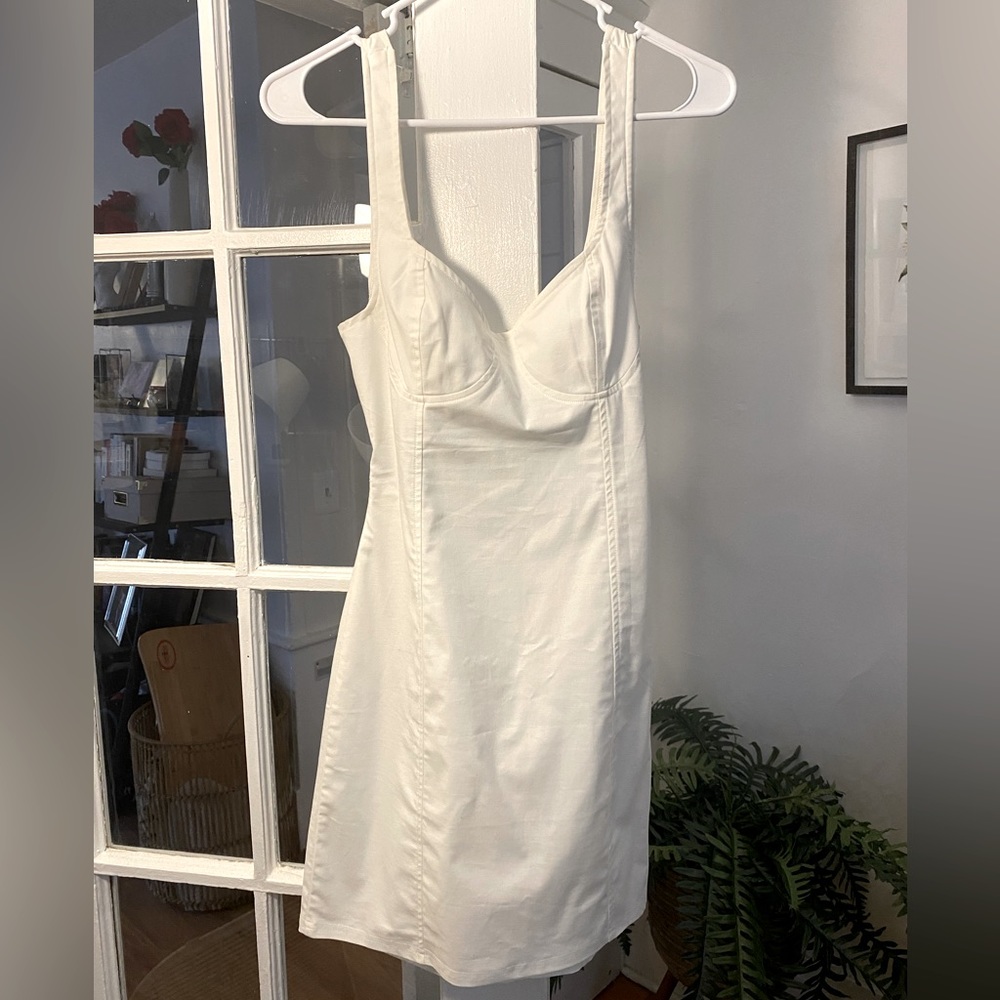 Light white dress. Slightly cinched around natural waist. Open area in back